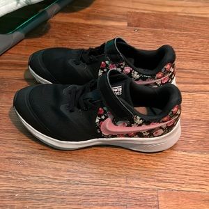 Black and floral Nike no tie tennis shoes.